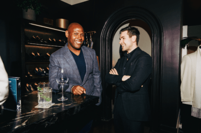 Two men dressed in tailored eveningwear—one in a navy check sport coat, the other in an all-black suit—enjoying drinks at Michael Andrews Bespoke during “A Night in Portofino” event - custom suits nyc bespoke tailor midtown, noho
