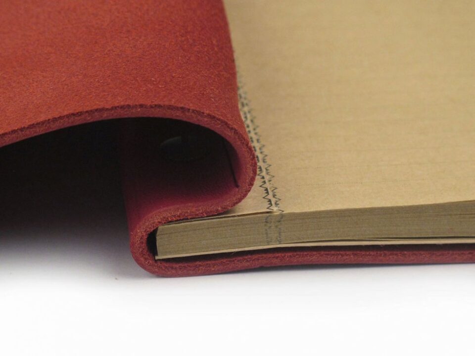 Red La Compagnie du Kraft Leather Notebook, close-up view with stitch details - custom suits nyc bespoke tailor midtown, noho
