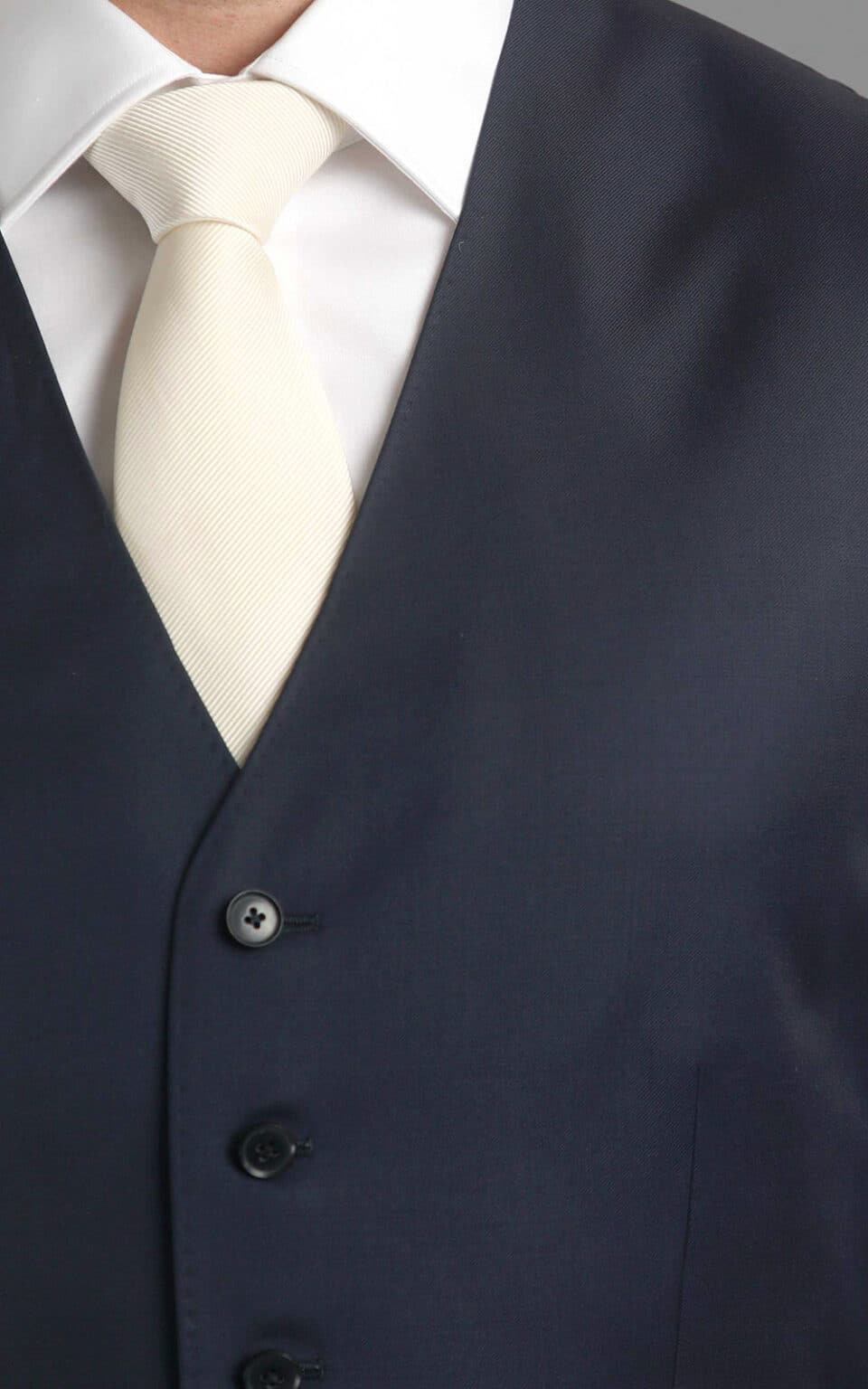 (product) Navy Blue Twill MTM Suit, close-up of vest with a white neck tie - custom suits nyc bespoke tailor midtown, noho