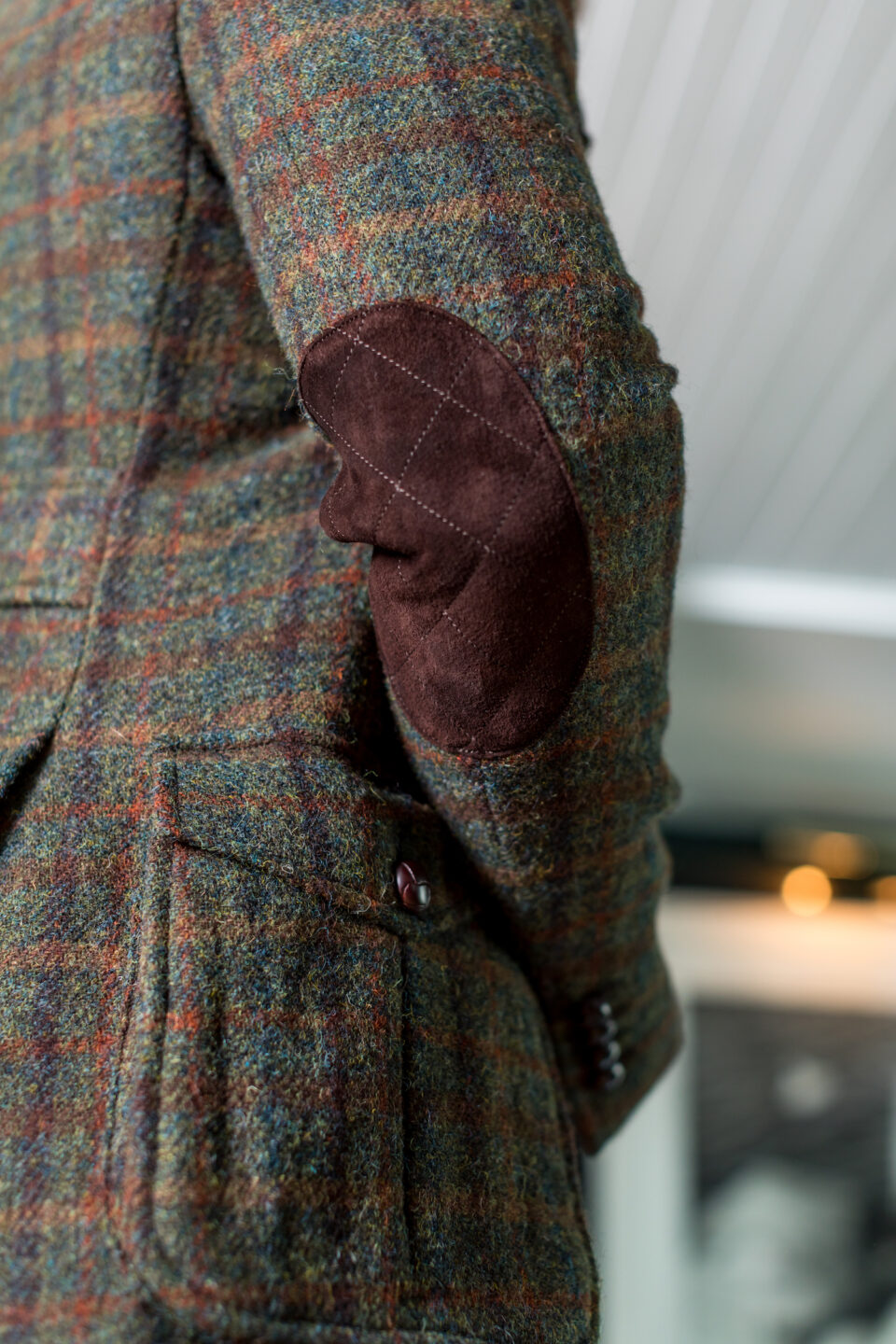 (product) Green With Multicoloured Overchecks Shooting Jacket, close-up view of suede elbow patch - custom suits nyc bespoke tailor midtown, noho