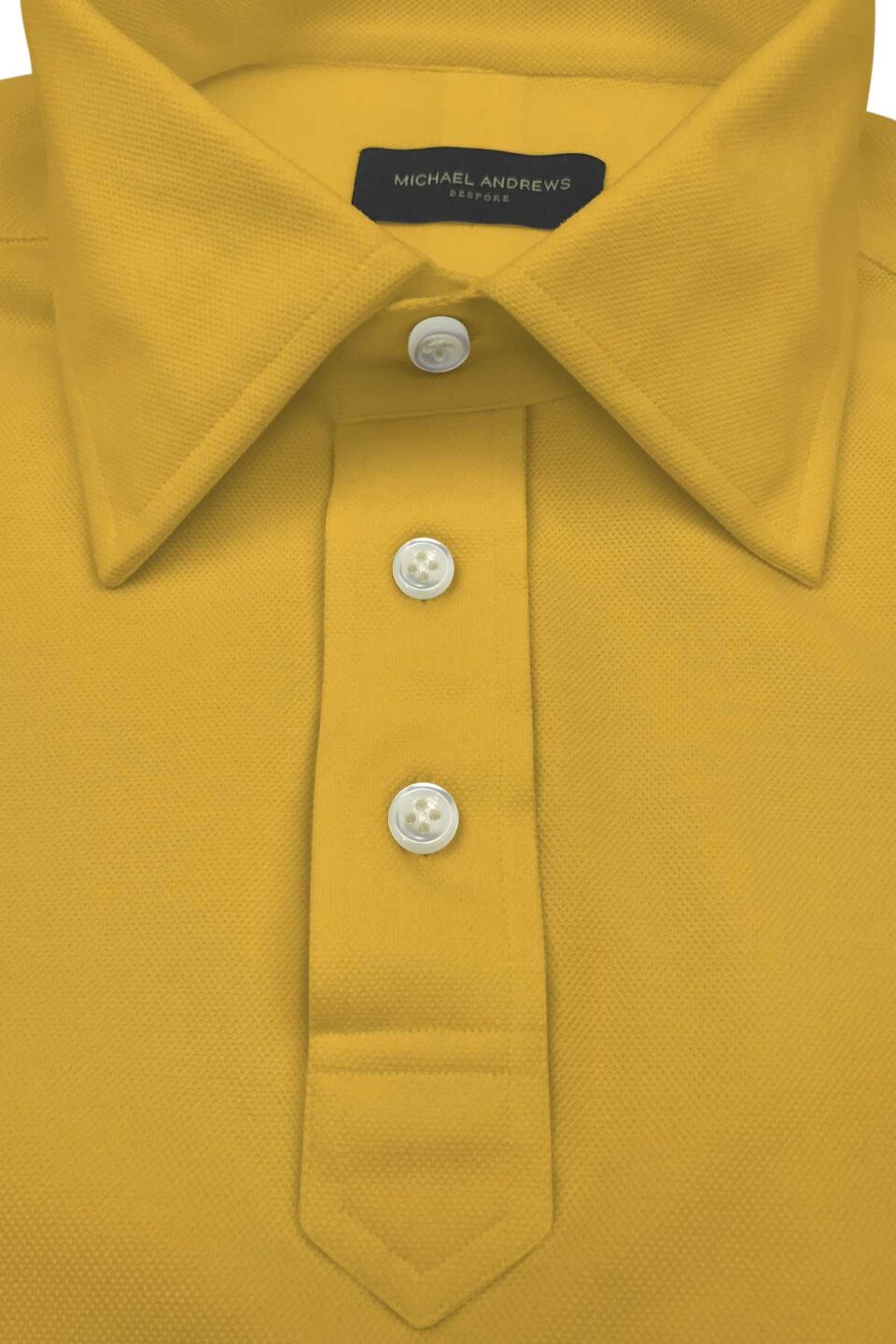 (product) Yellow Pique Polo Shirt, close-up of collar and buttons - custom suits nyc bespoke tailor midtown, noho