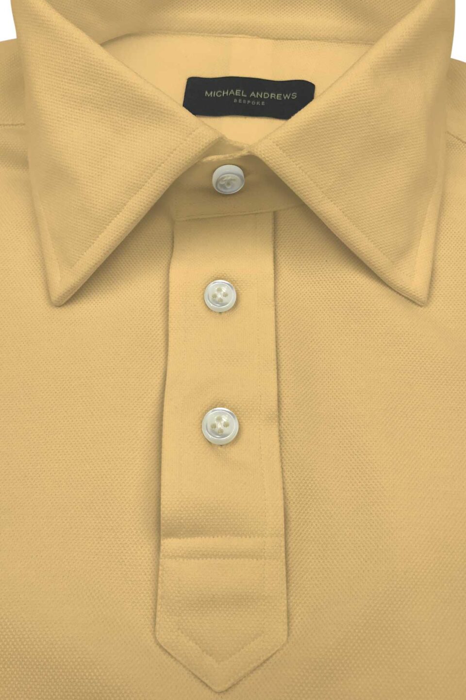 (product) Pale Yellow Pique Polo Shirt, close-up of collar and buttons - custom suits nyc bespoke tailor midtown, noho