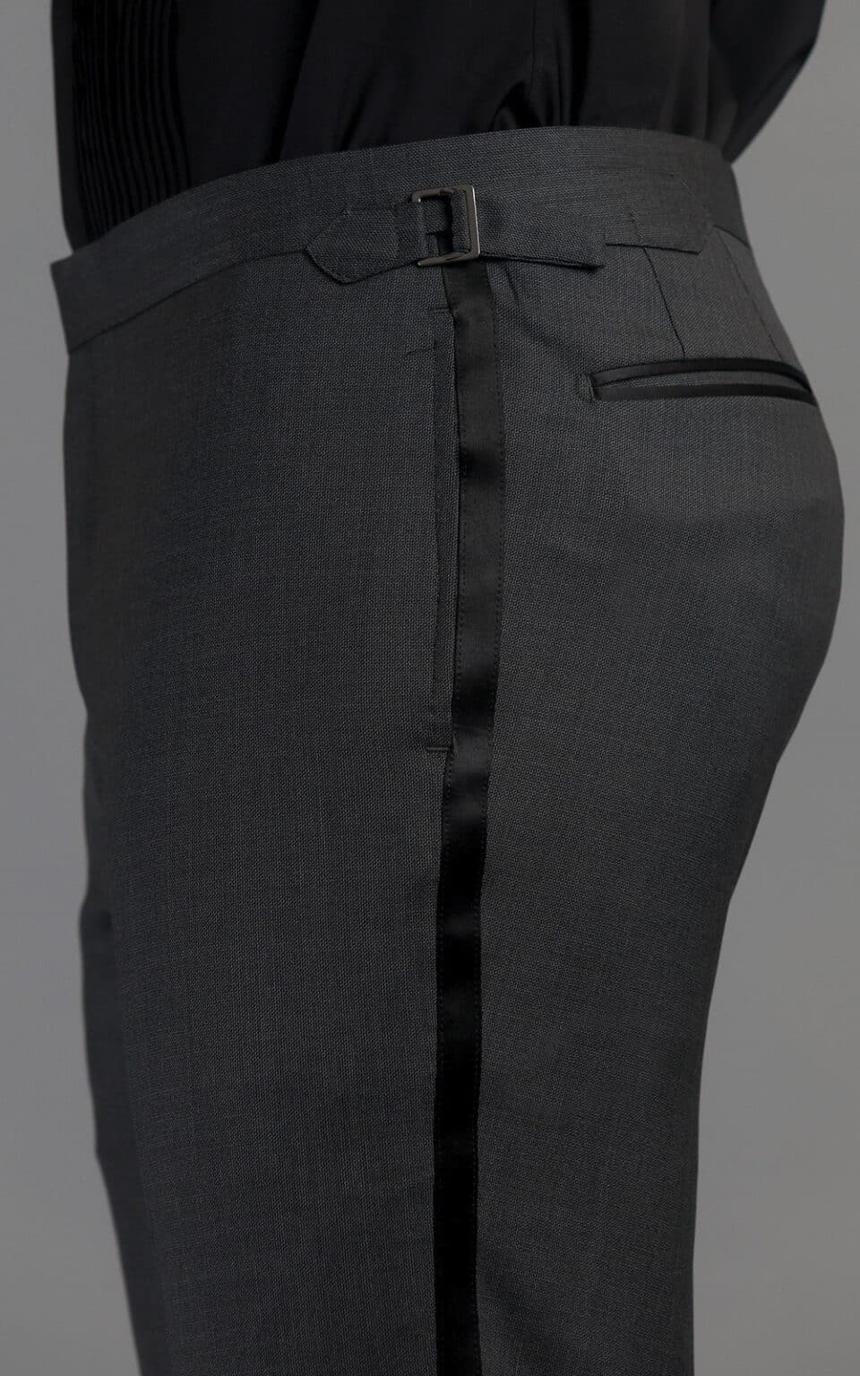 Close-up of grey wool MTM tuxedo trousers with side adjuster and pocket detail
