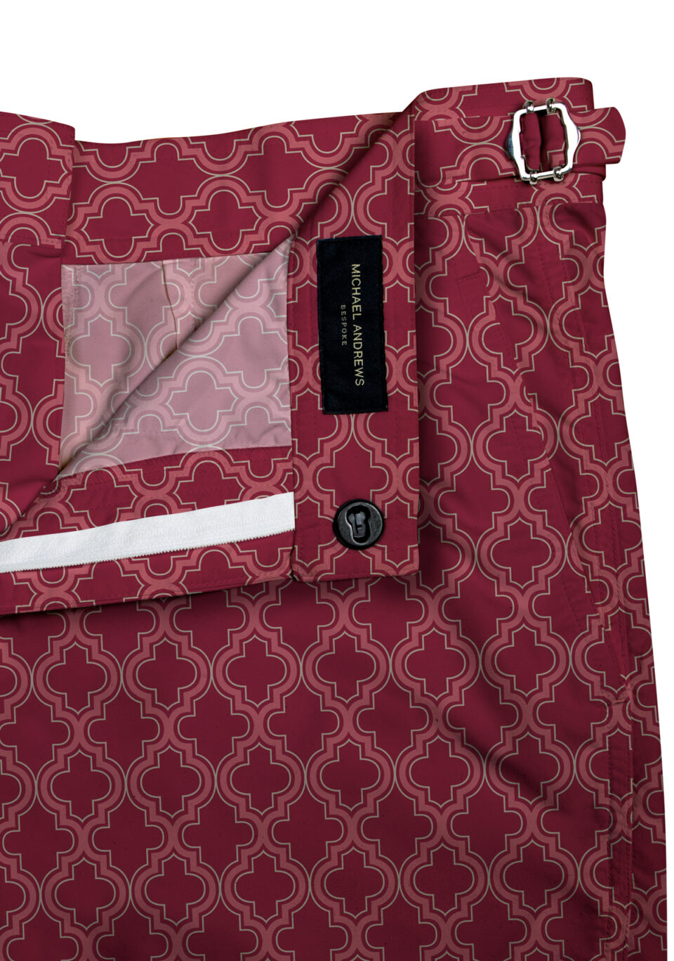 (product) Red Moroccan Swim Shorts, close-up view showcasing lining and adjustable side tabs