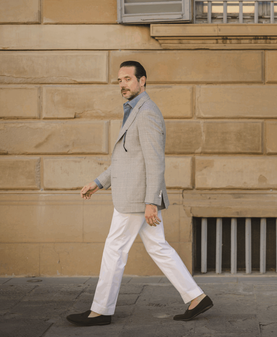 Brian wearing white cotton pants and gray plaid sport coat