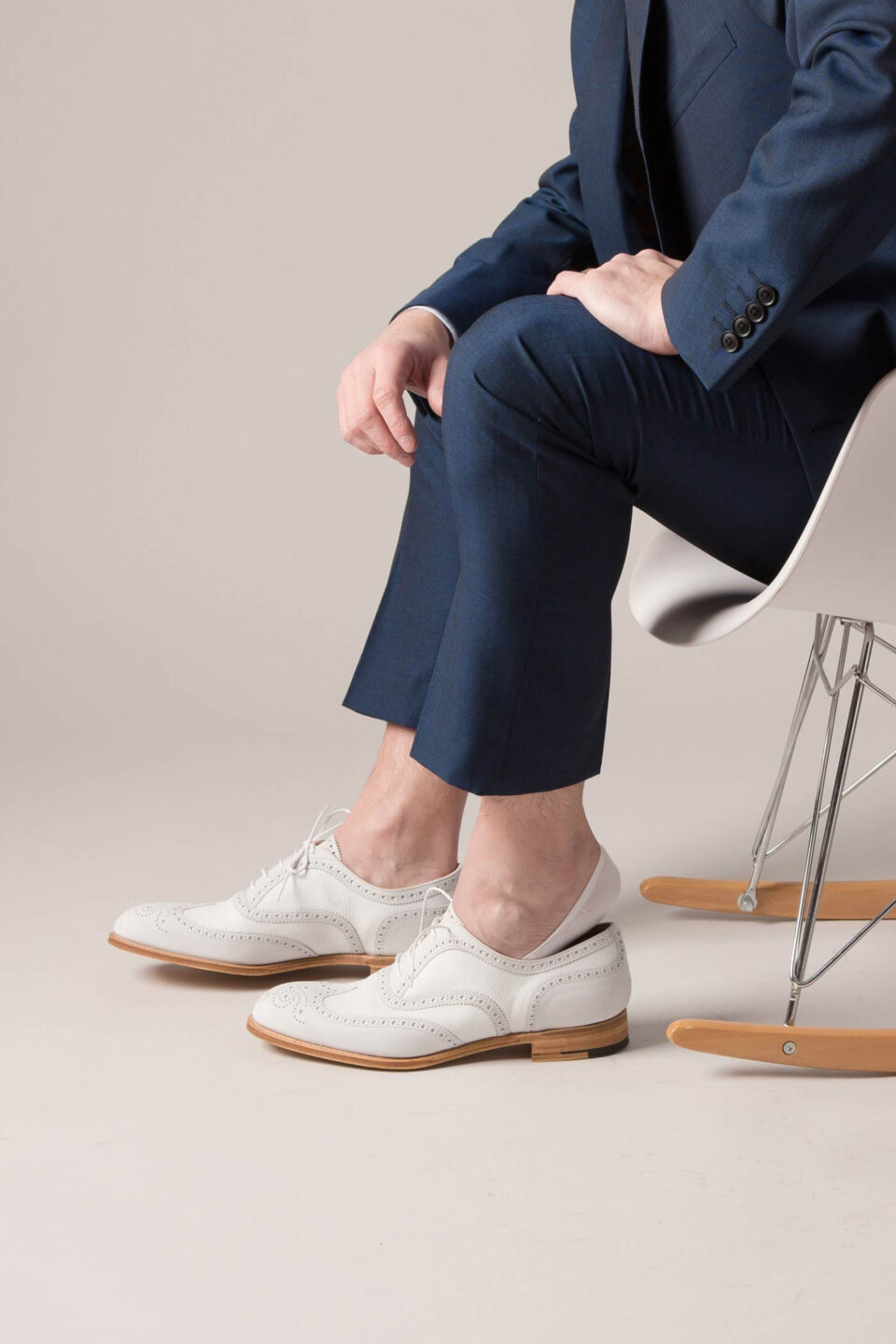 (product) Pantherella Mahon Wool No-Show Socks - Light Khaki, paired with sleek white derby shoes and tailored navy pants