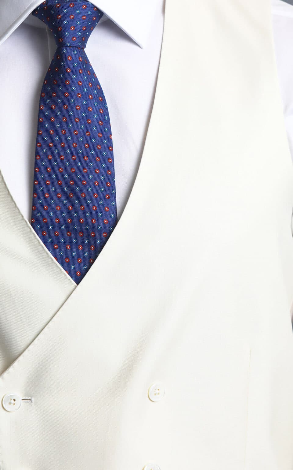 Cream vest paired with a royal blue MTM suit, shown in a close-up view highlighting the contrast