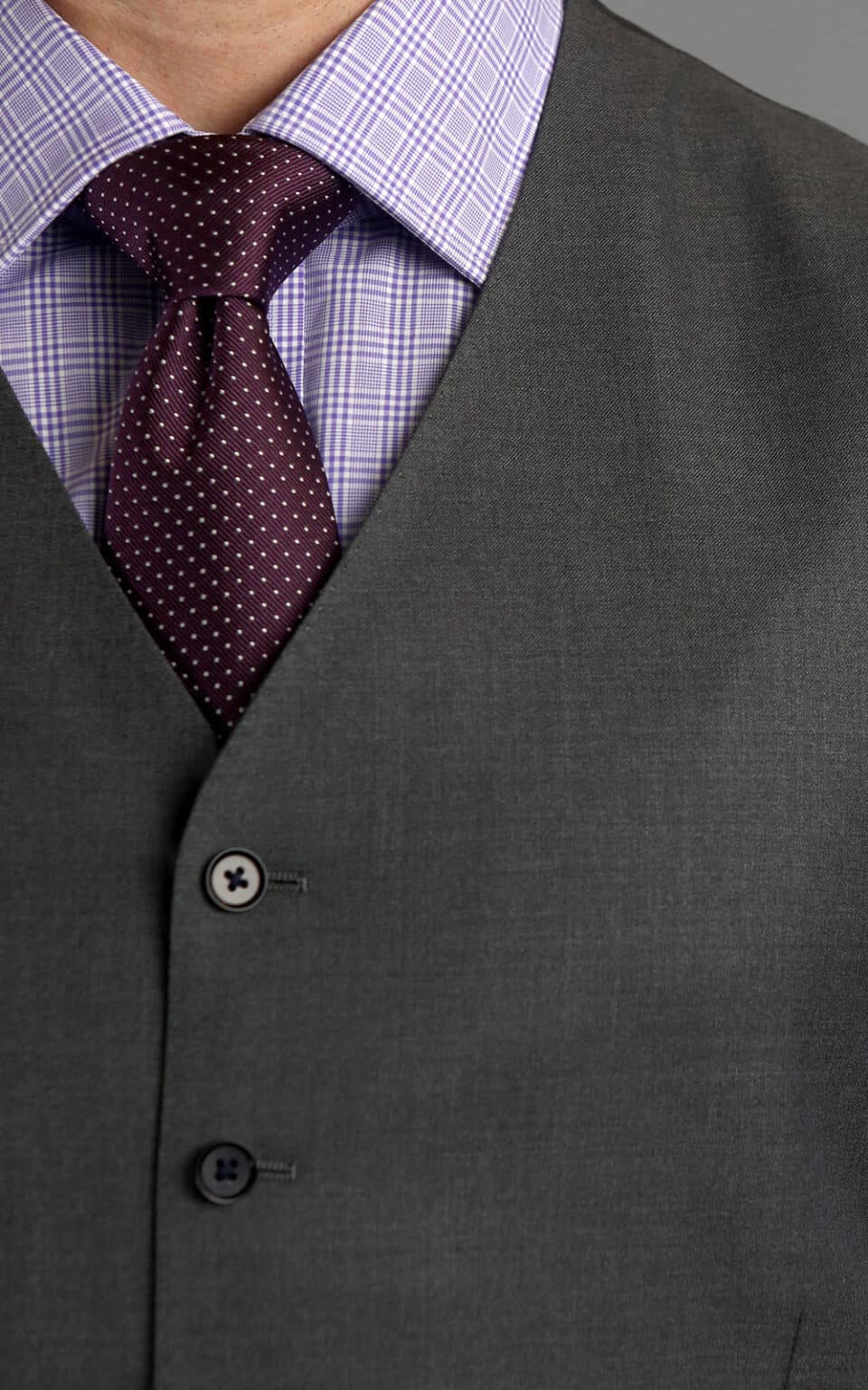 Grey sharkskin suit vest paired with a lilac shirt and textured burgundy tie