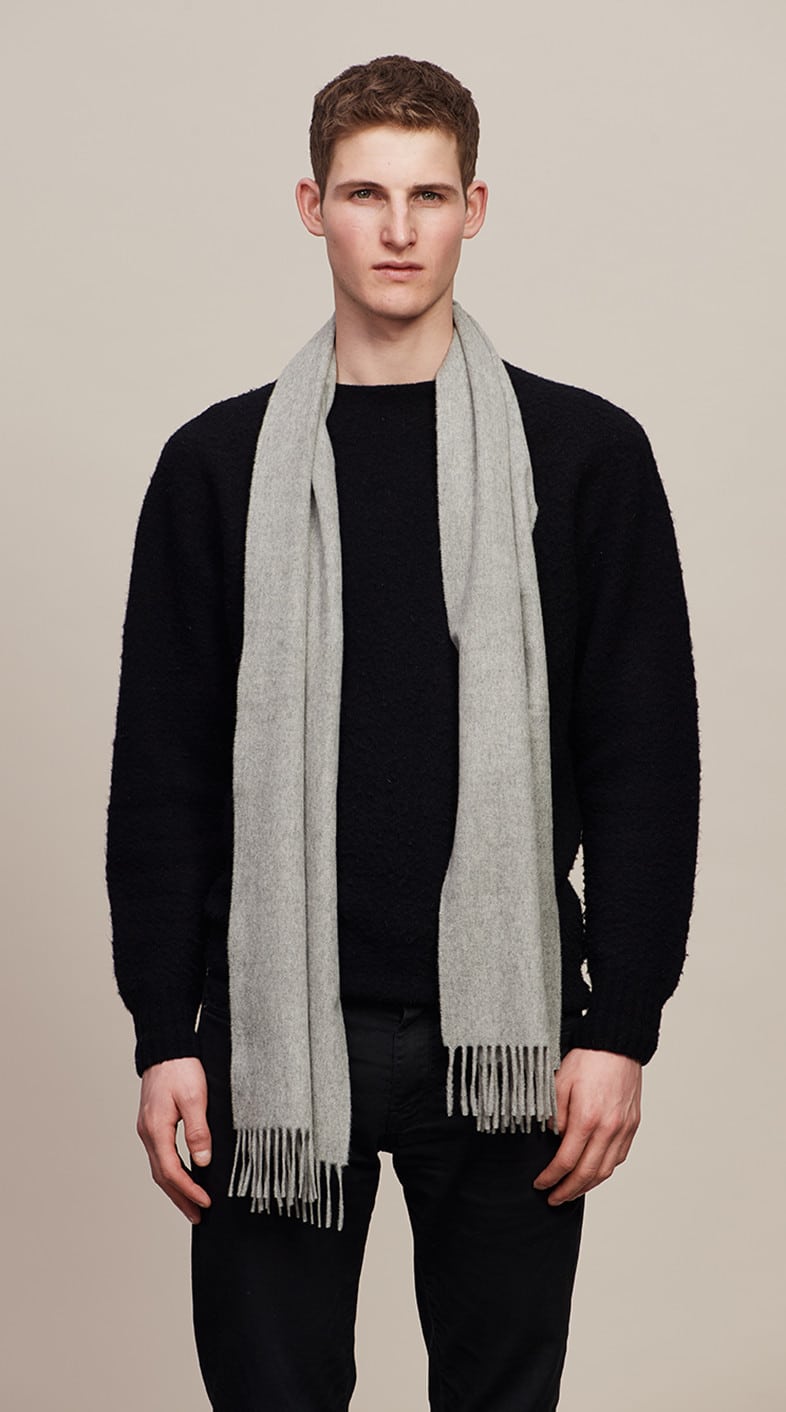 Model wearing a Light Grey Classic Cashmere Scarf over a black sweater