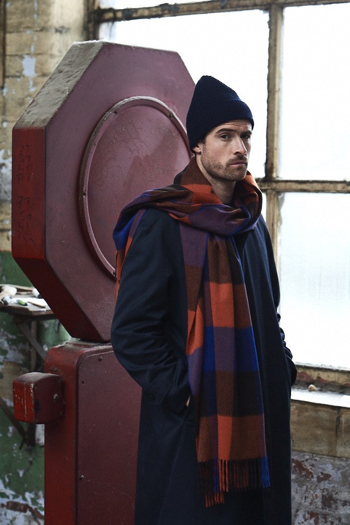(product) Cobalt Block Check Cashmere Stole, modeled with a navy jacket and beanie