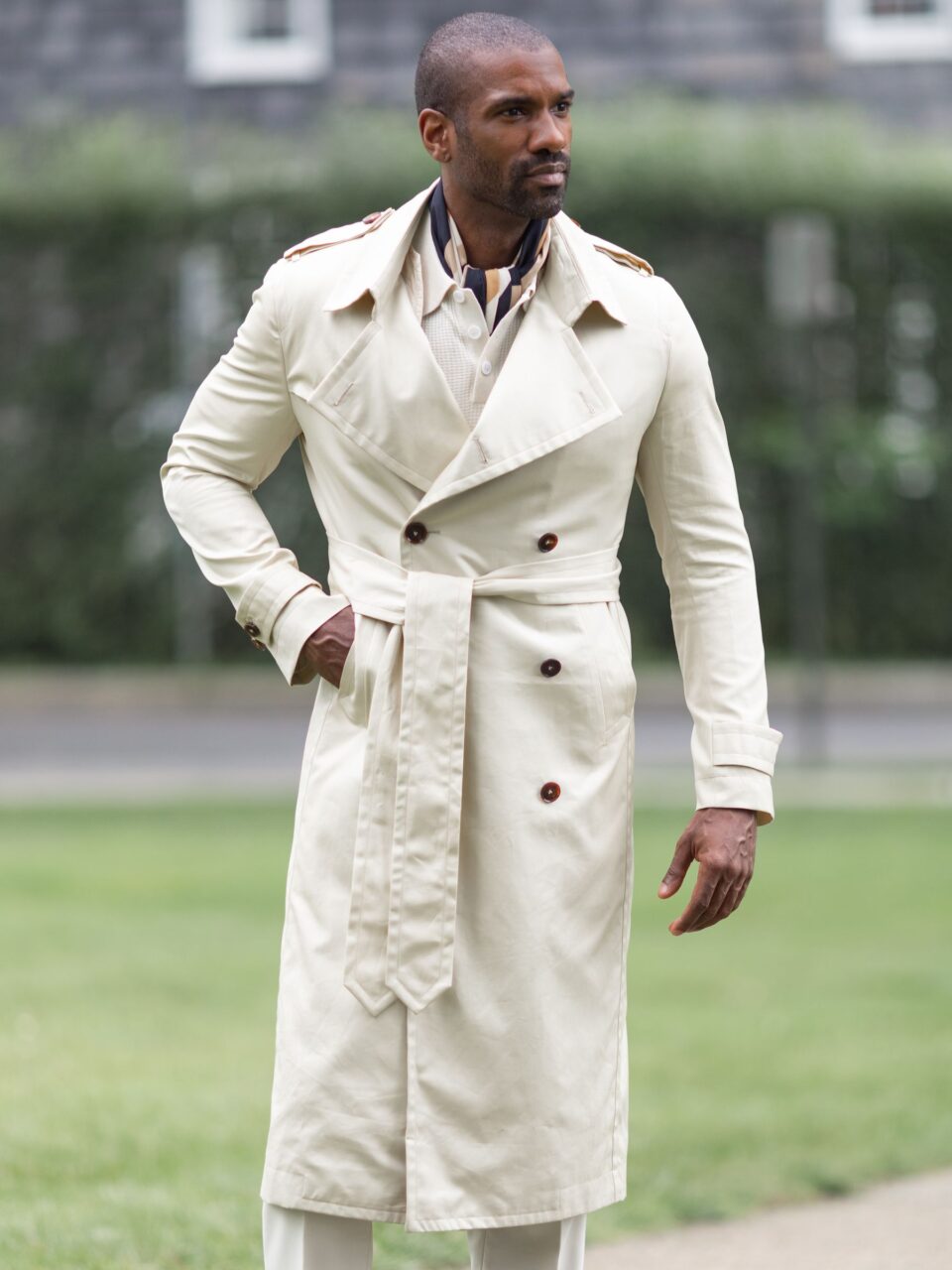 Full-length Cream Cotton Trench Coat showcasing structured shoulders and buttoned details