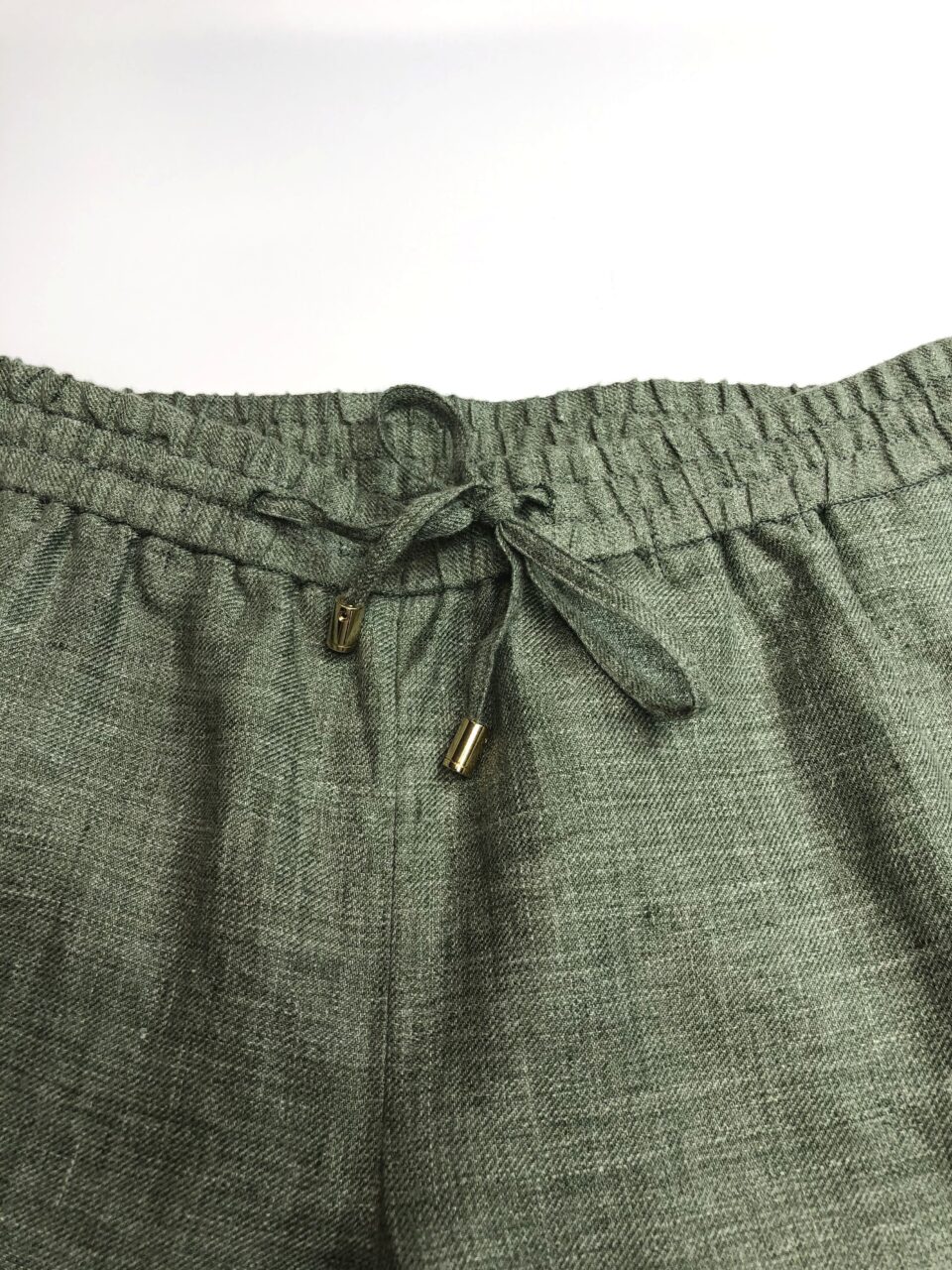 (product) Green Linen Elastic Waist Cargo Pants, close-up view of waistband