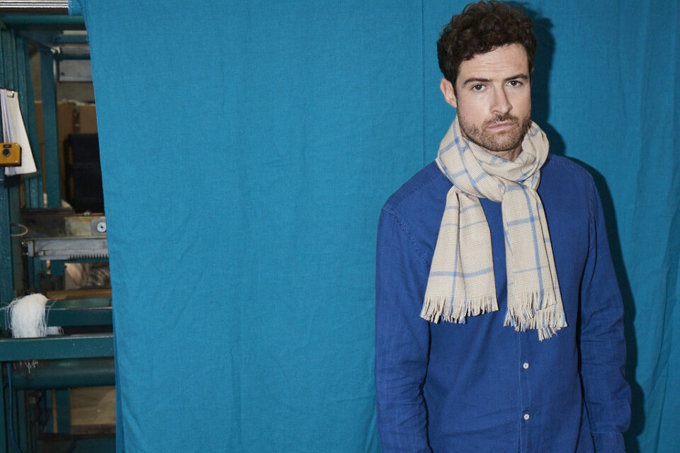 (product) Camel Lightweight Merino Semi-Plain Scarf worn by a model