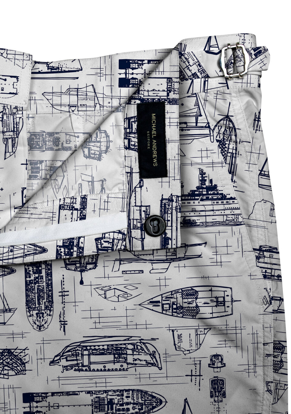 (product) White Swim Shorts with Navy Boats, close-up view showcasing lining and adjustable side tabs