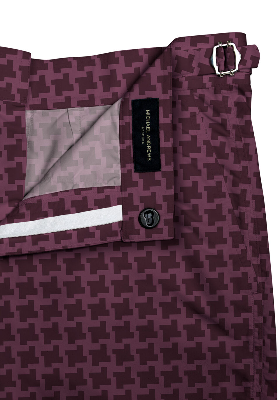 (product) Burgundy Houndstooth Swim Shorts, close-up view showcasing lining and adjustable side tabs