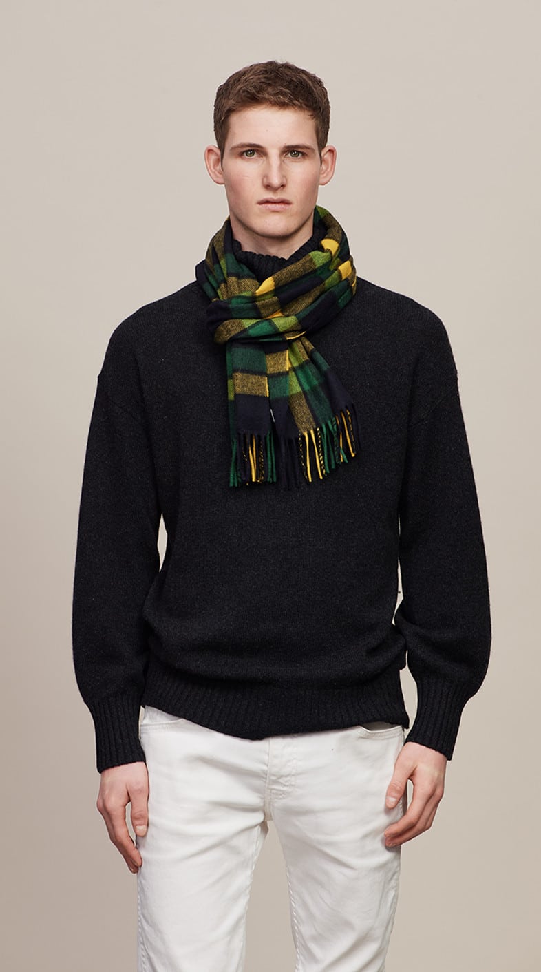 Man styled with a Chatham navy, mid green, and yellow tartan scarf