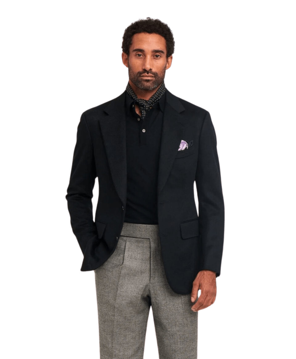 Model wearing a black silk cashmere long-sleeve polo paired with a black blazer and grey trousers