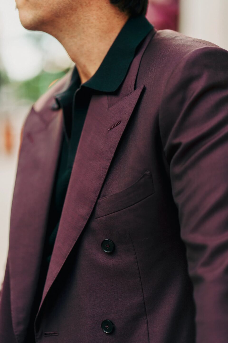 Close-up of a burgundy double-breasted suit jacket with peak lapels