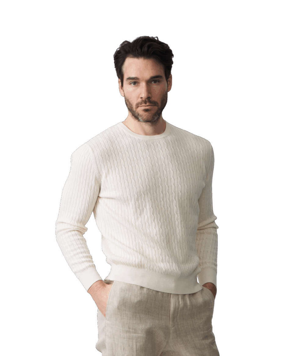 Model wearing a custom white merino wool cable knit sweater