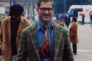 Pitti Uomo GQ-style street look with a green plaid tailored jacket, denim shirt, patterned scarf, and rust trousers in Florence. - custom suits nyc bespoke tailor midtown, noho